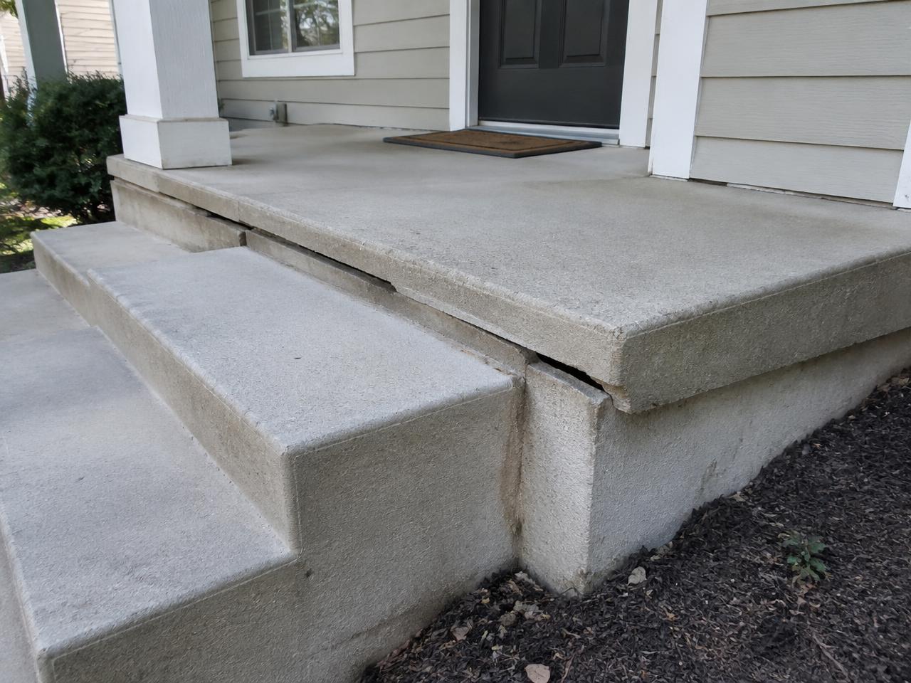 Concrete porch and steps pulling away from a house
